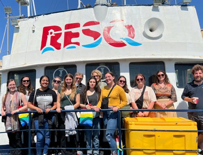 Students pose on the deck of the RESQ ship in Sicily