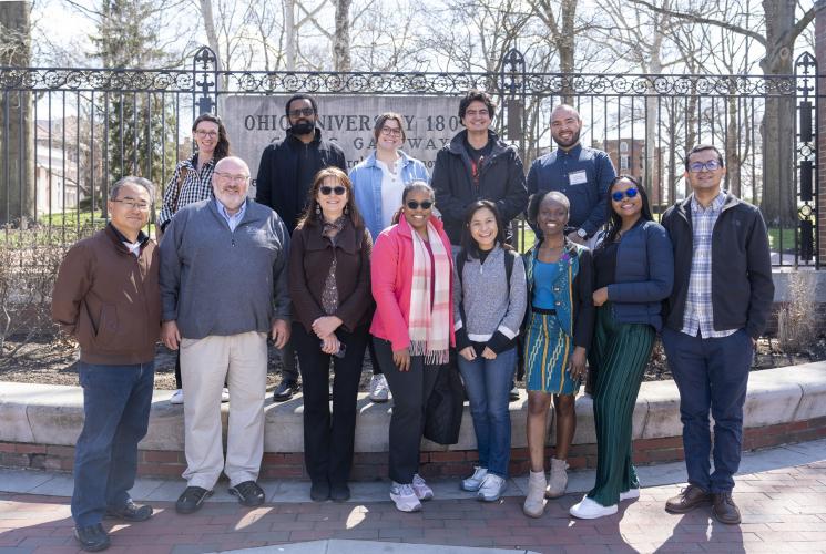 The Hubert H. Humphrey Fellows and several OHIO representatives pose for a photo at the College Gate