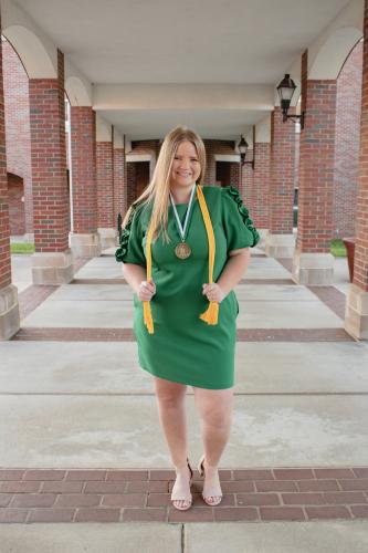 graduate with cords and medal