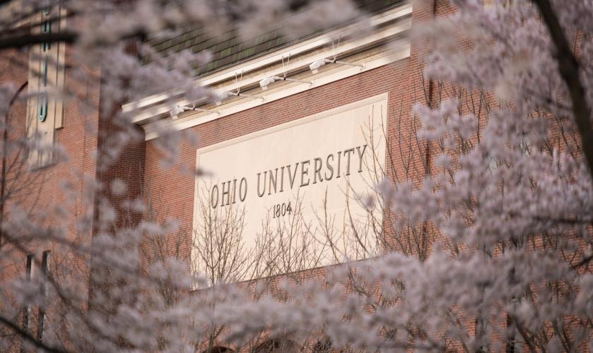 Cherry blossoms bloom on trees near the Ohio University sign at Peden Stadium