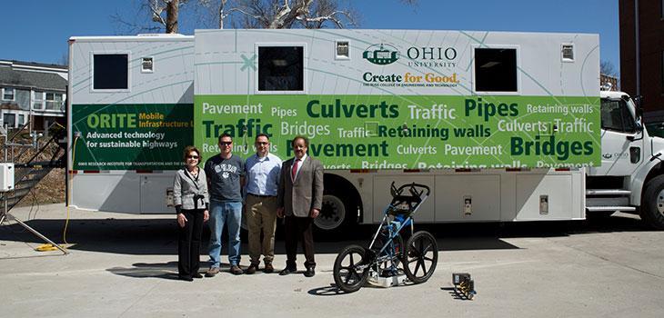 ORITE member stand in front of the Mobile Civil Infrastructure Laboratory