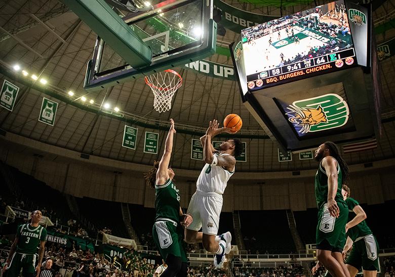 An Ohio University Men's Basketball player goes up for a lay up.