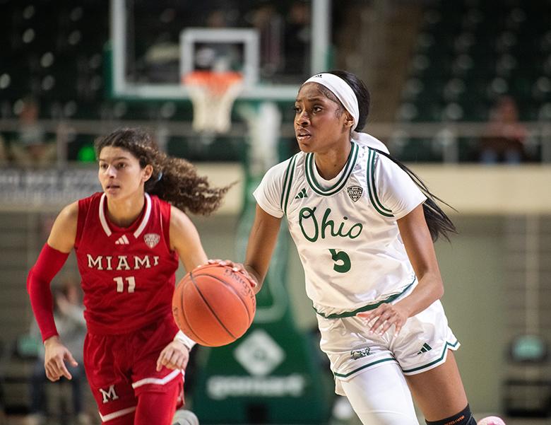 An Ohio University Women's Basketball Player dribbles up court.