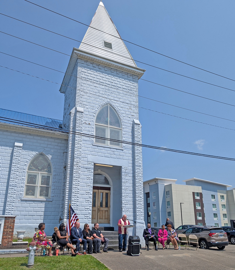 Chris Saunders speaks at the dedication ceremony outside of the Quinn Chapel AME Church