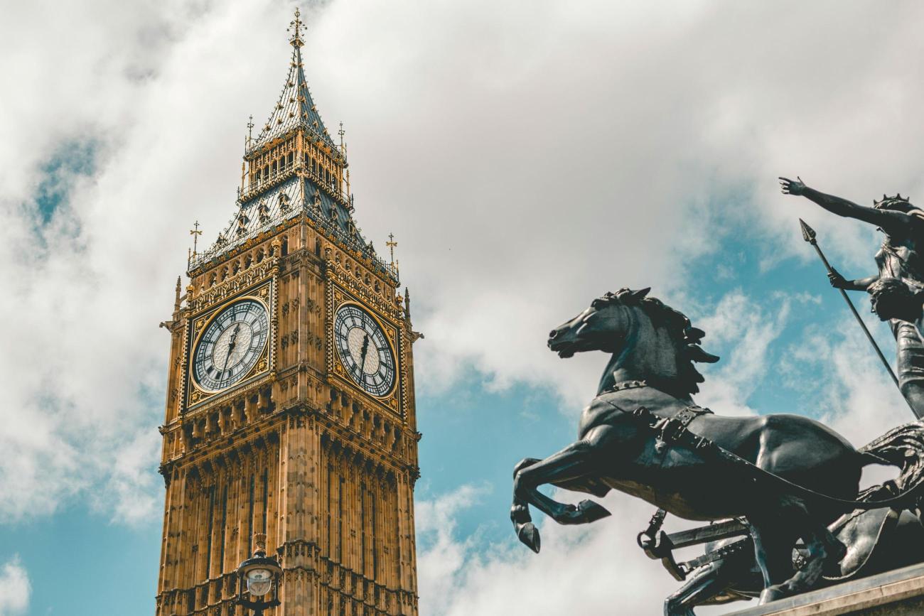 A clocktower in London and a statue of a horse