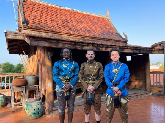 The men standing in front of a traditional Lanna house in Thialand