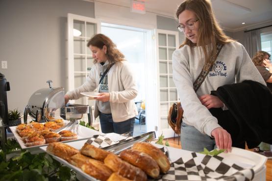 An OHIO student and her mother choose food items at the 2024 Tea With The President event