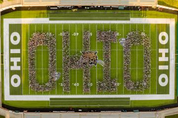 Students spelling out OHIO by standing in Peden Stadium