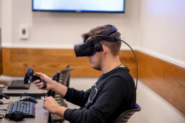 An Ohio University student is shown using virtual reality equipment in the GRID Lab