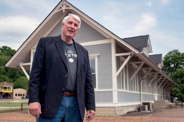 Gary Wolf stands in front of the Athens Depot