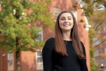 Bella Miller poses outside of residential halls.