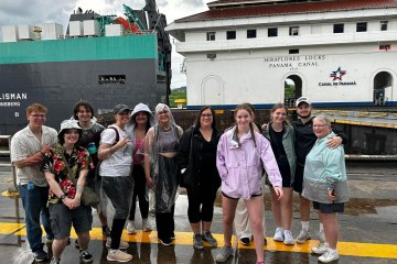 OHIO students and faculty stand in front of a building at the Panama Canal