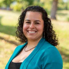 Paola Sofia Muñoz Gamboa smiling and wearing a black shirt and teal cardigan.