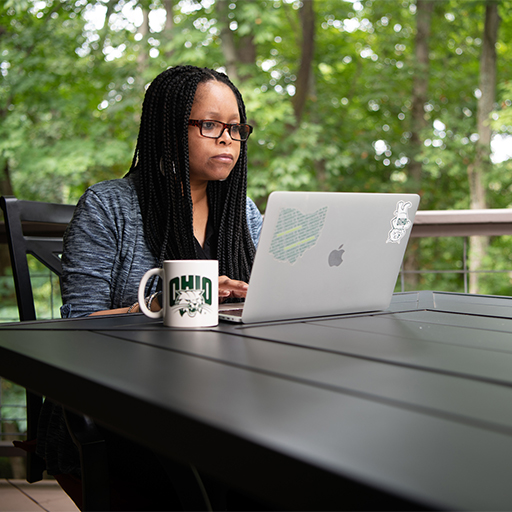A student works at a laptop