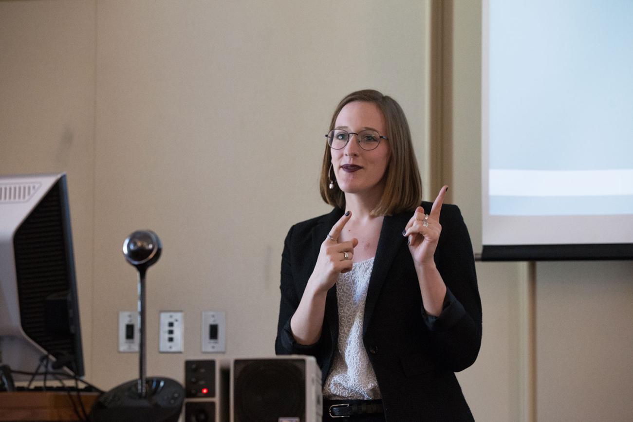 Woman in front of white board presenting to an executive mpa class