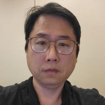 Kyong Lim's profile picture Headshot of Kyong Lim, man smiling at camera with short black hair, wireframes glasses and a dark shirt.